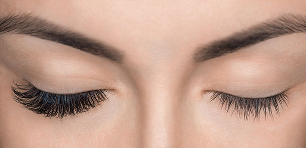 Female eyes closed, one eye with and one eye without lash extensions